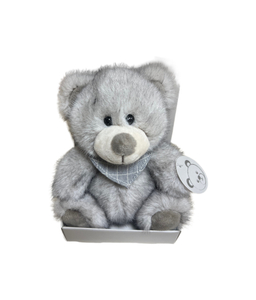 Gray plush teddy bear wearing a gray bandana, placed in the box